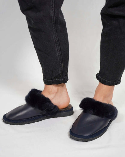 Sheepskin Wool Leather Fur Slippers Blue for Women worn by a model with casual black pants, showcasing comfort and style.