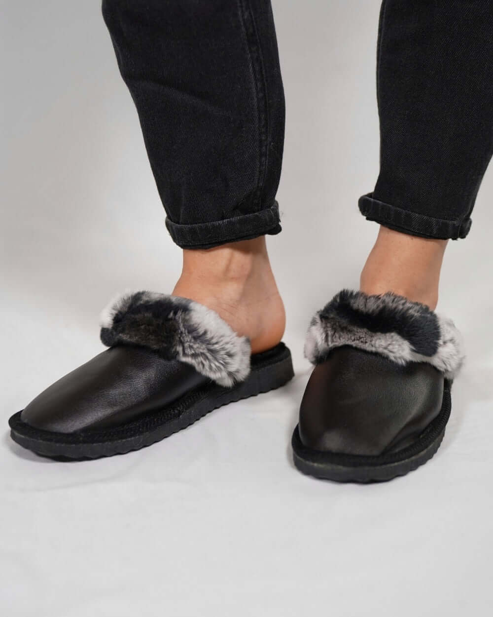 Sheepskin Wool Leather Fur Slippers Black with Gray Top on feet, showcasing the stylish and comfortable design.