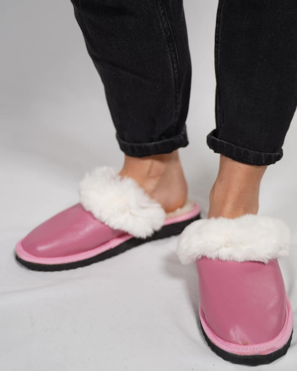 Sheepskin Wool Leather Fur Slippers Pink for Women on feet, showcasing luxury and comfort in stylish design.