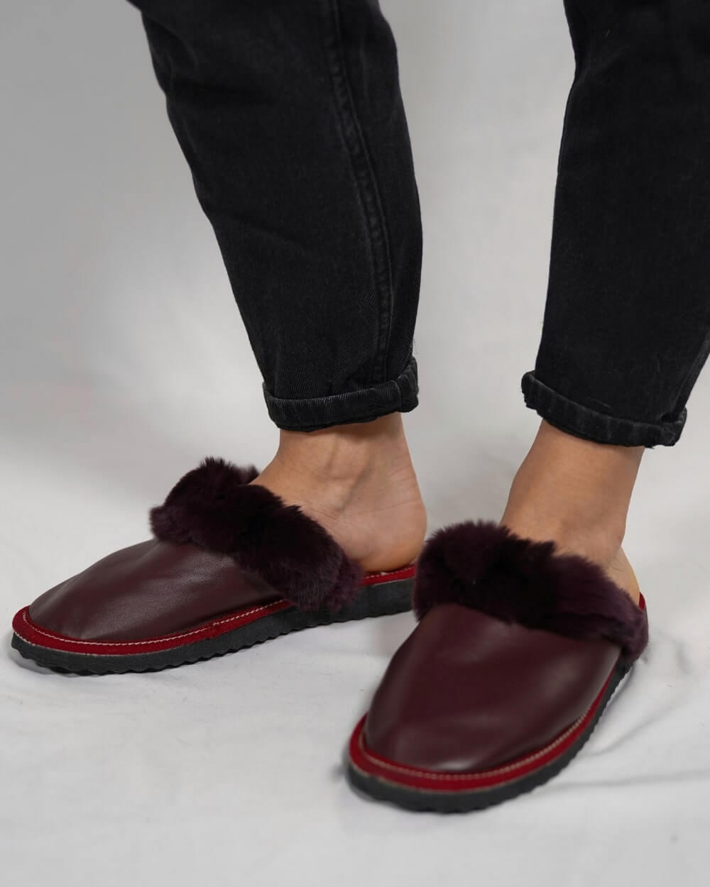 Sheepskin Wool Leather Fur Slippers Burgundy - Tatifurs worn by a model, showcasing comfort and style.