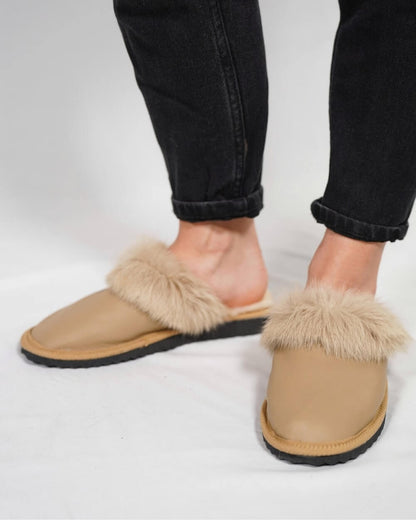 Sheepskin Wool Leather Fur Slippers Camel for Women being worn with black jeans.