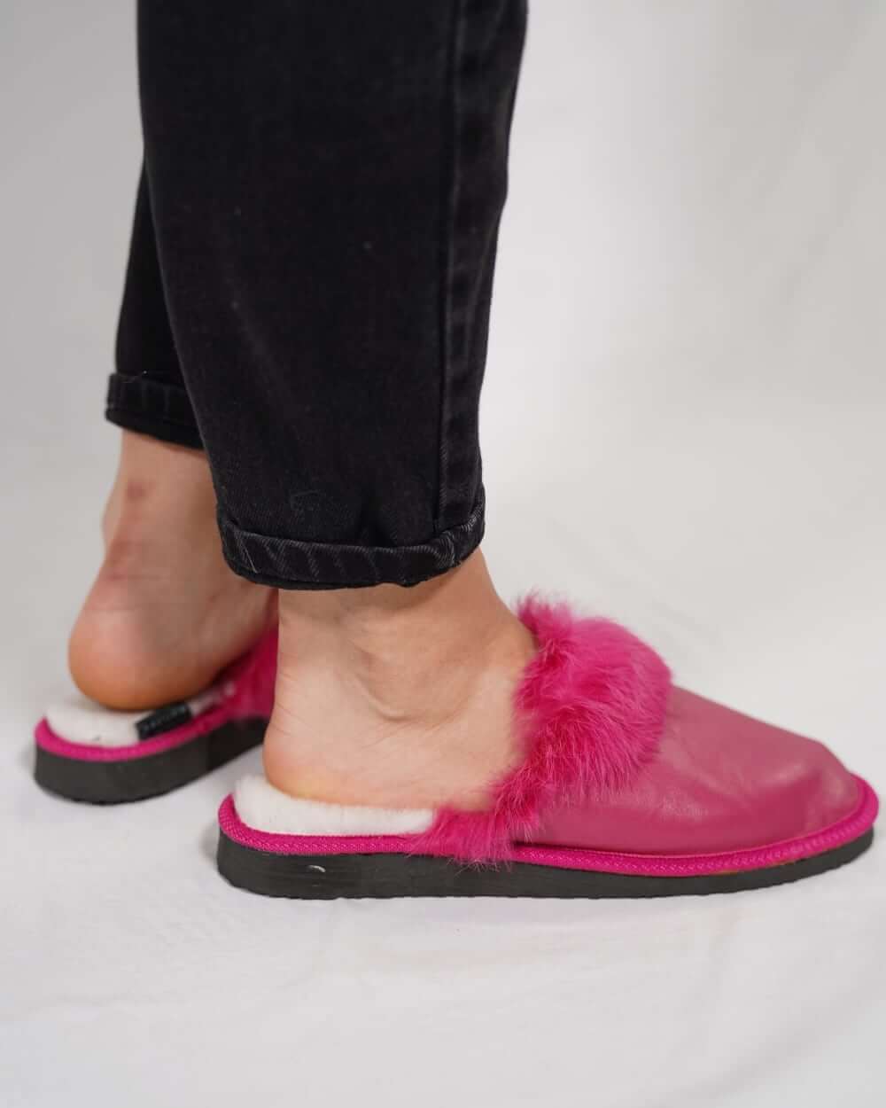 Sheepskin Wool Leather Fur Slippers Fuchsia for Women worn with black jeans, showcasing comfort and style.