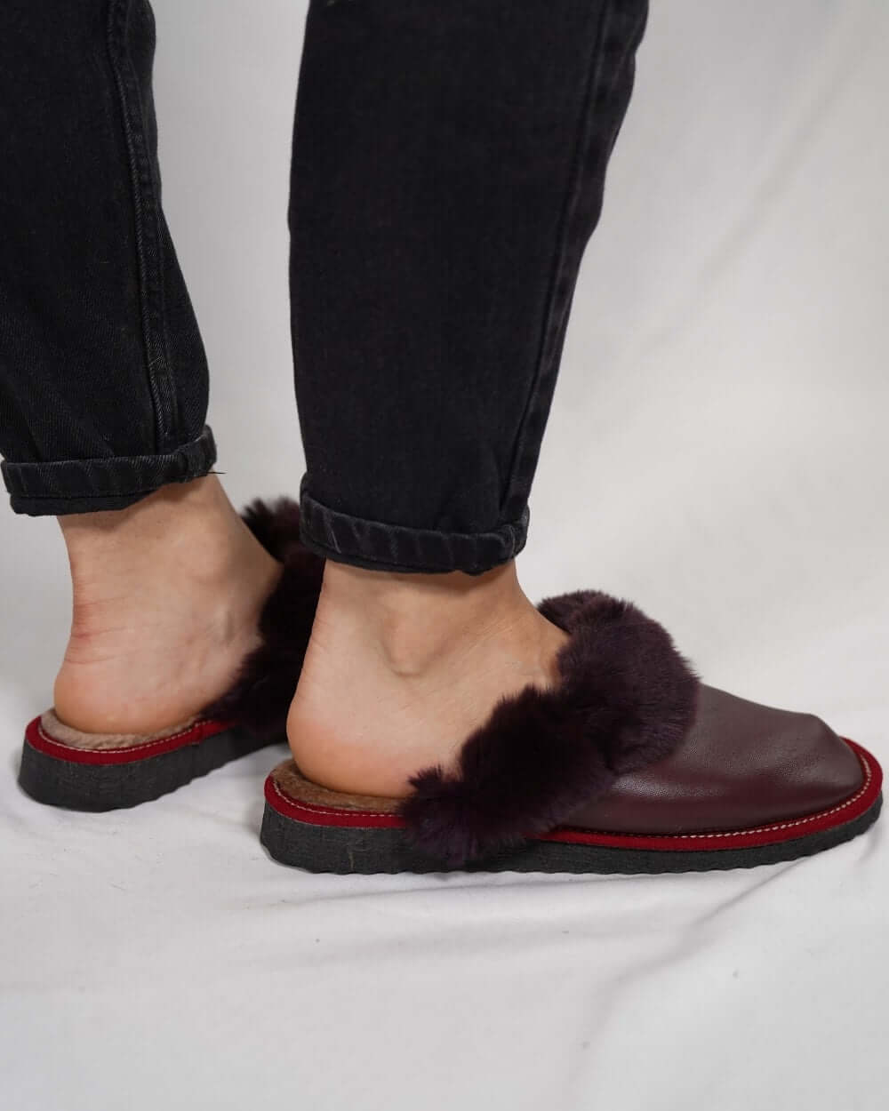 Sheepskin Wool Leather Fur Slippers Burgundy - Tatifurs worn by a person, showcasing the luxurious design and comfort.
