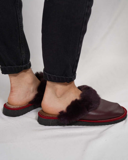 Sheepskin Wool Leather Fur Slippers Burgundy - Tatifurs worn by a person, showcasing the luxurious design and comfort.
