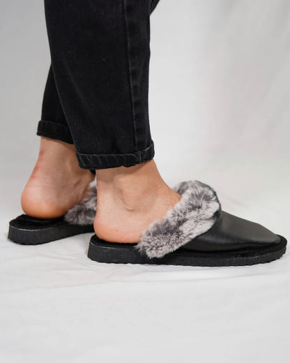 Sheepskin Wool Leather Fur Slippers Black with Gray Top worn by a woman, showcasing comfort and style.