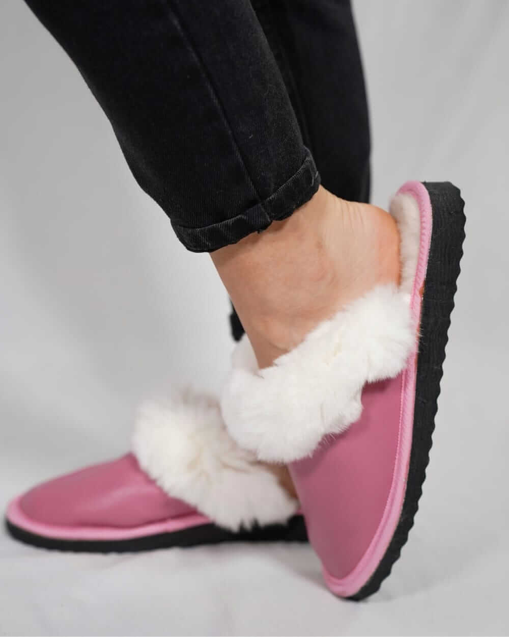Sheepskin Wool Leather Fur Slippers Pink for Women worn by a model showing comfort and style.
