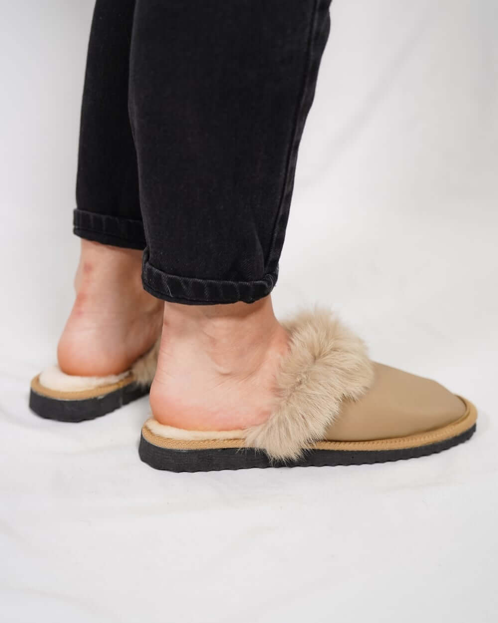 Sheepskin Wool Leather Fur Slippers Camel for Women worn on feet, showcasing luxurious comfort and style.