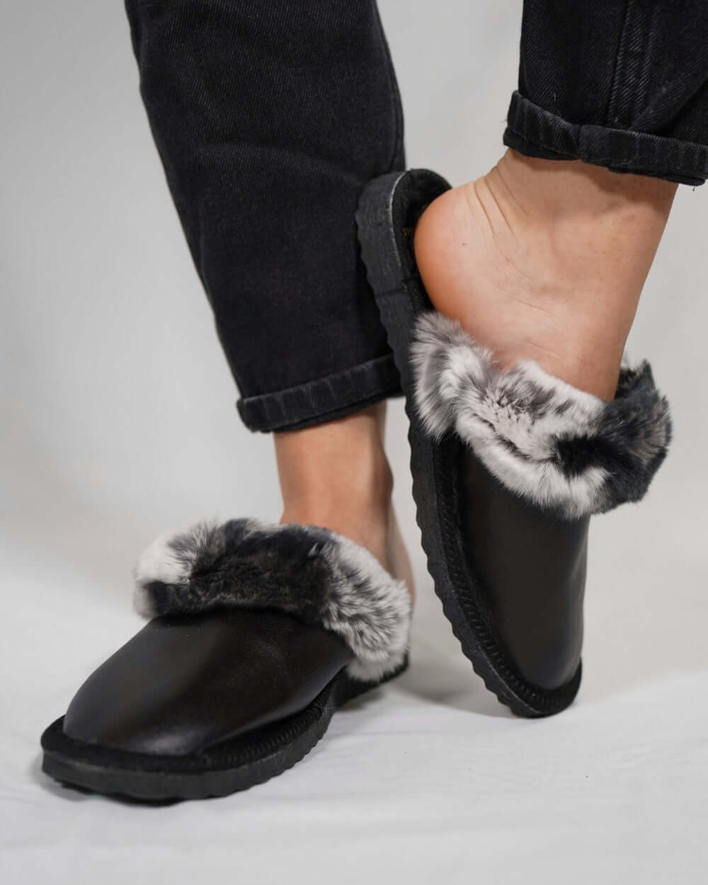 Sheepskin Wool Leather Fur Slippers Black with Gray Top worn by a person, showcasing comfort and style.