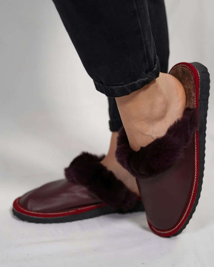 Sheepskin Wool Leather Fur Slippers Burgundy - Tatifurs worn by a woman, showcasing comfort and luxury.