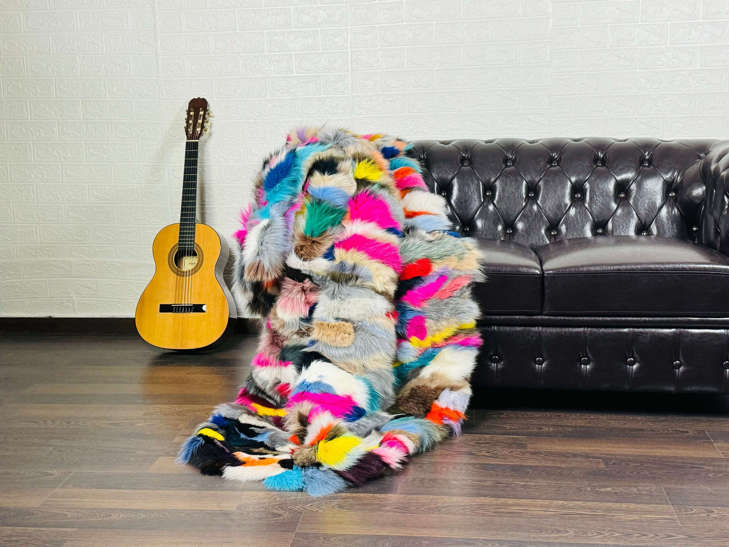 Fox Fur Blanket Throw Colorful - Tatifurs draped over a sofa with a guitar in the background, showcasing vibrant colors.