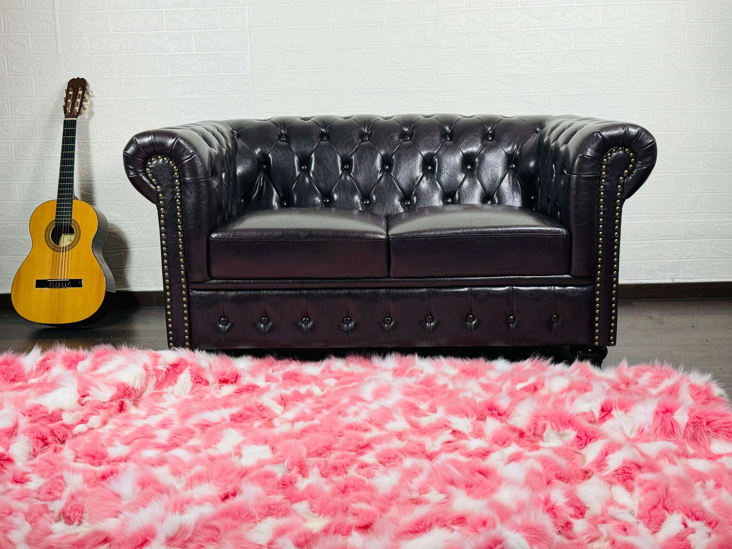 Fox Fur Blanket Throw Pink White - Tatifurs on a stylish couch with a guitar in an elegant living room setting.
