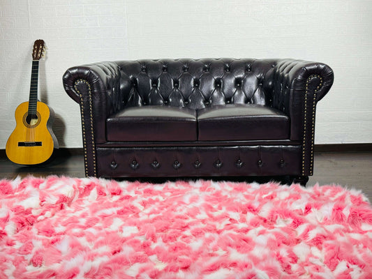 Fox Fur Blanket Throw Pink White - Tatifurs on a stylish couch with a guitar in an elegant living room setting.