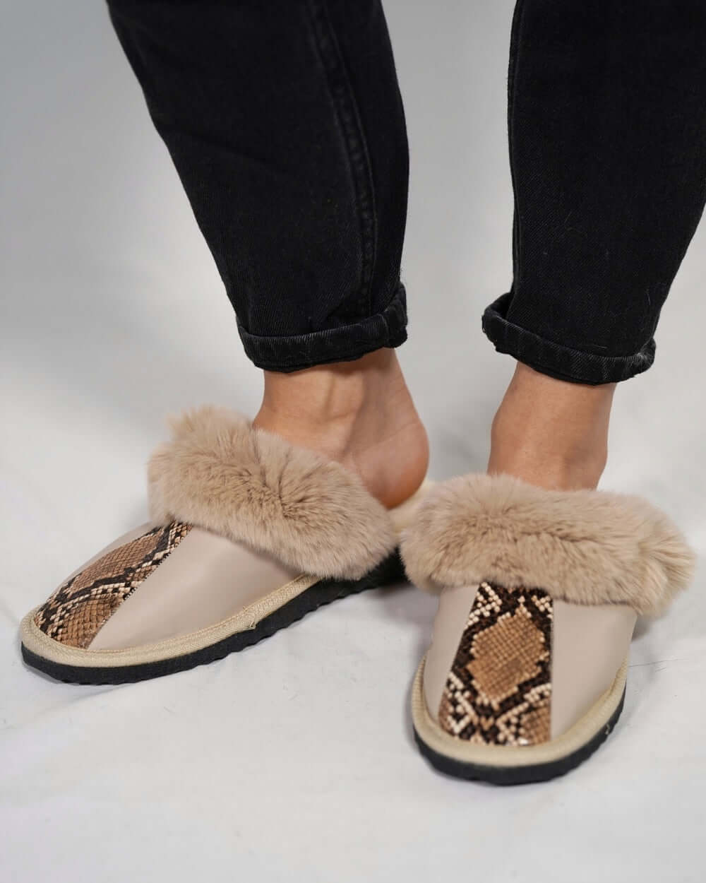 Sheepskin Wool Leather Fur Slippers Beige Leopard worn with casual black jeans, showcasing luxurious style and comfort.