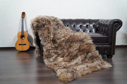 Alpaca throw blanket iceberg natural wool draped over sofa showing cool luminous pale iceberg tone and soft alpaca texture — Greek craftsmanship, TatiFurs
