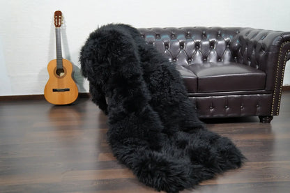 Alpaca throw blanket black folded showing velvet cotton backing and black alpaca wool face — Greek craftsmanship, TatiFurs
