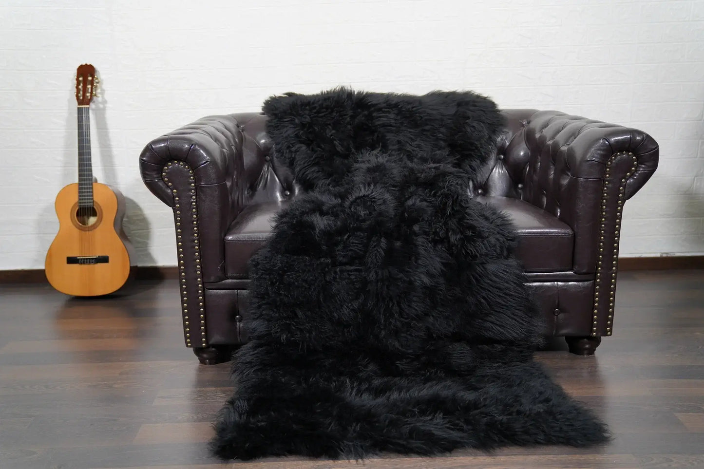 Alpaca throw blanket black wool draped over sofa showing deep commanding black tone and soft alpaca texture — Greek craftsmanship, TatiFurs
