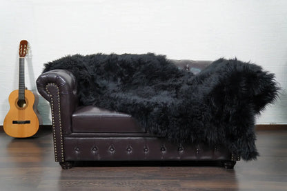 Alpaca throw blanket black close-up texture showing black alpaca wool fiber softness and deep commanding tone — Greek craftsmanship, TatiFurs
