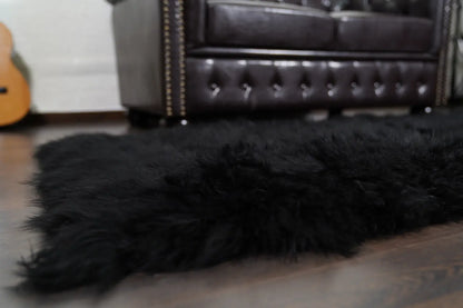 Alpaca throw blanket black corner detail showing black alpaca wool fiber quality and deep commanding tone — Greek craftsmanship, TatiFurs
