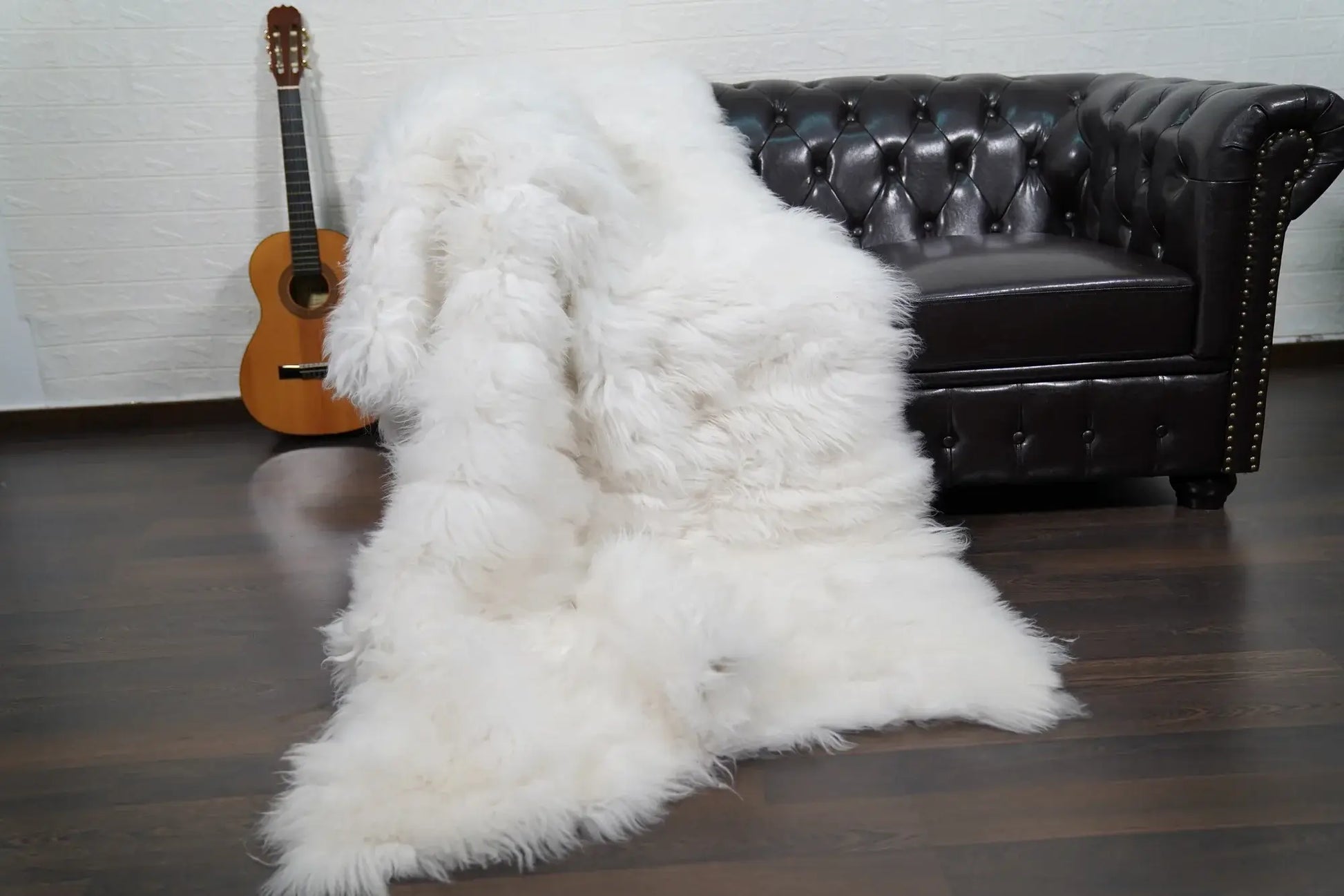 Alpaca throw blanket white shown draped over bed displaying pure luminous natural white alpaca wool tone across full blanket surface — Greek craftsmanship, TatiFurs
