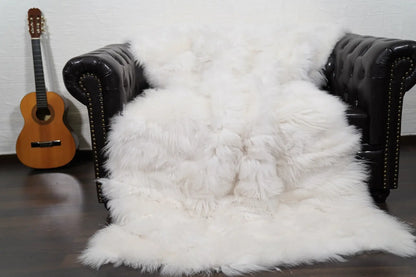 Alpaca throw blanket white natural wool draped over sofa showing pure luminous white tone and soft alpaca texture — Greek craftsmanship, TatiFurs
