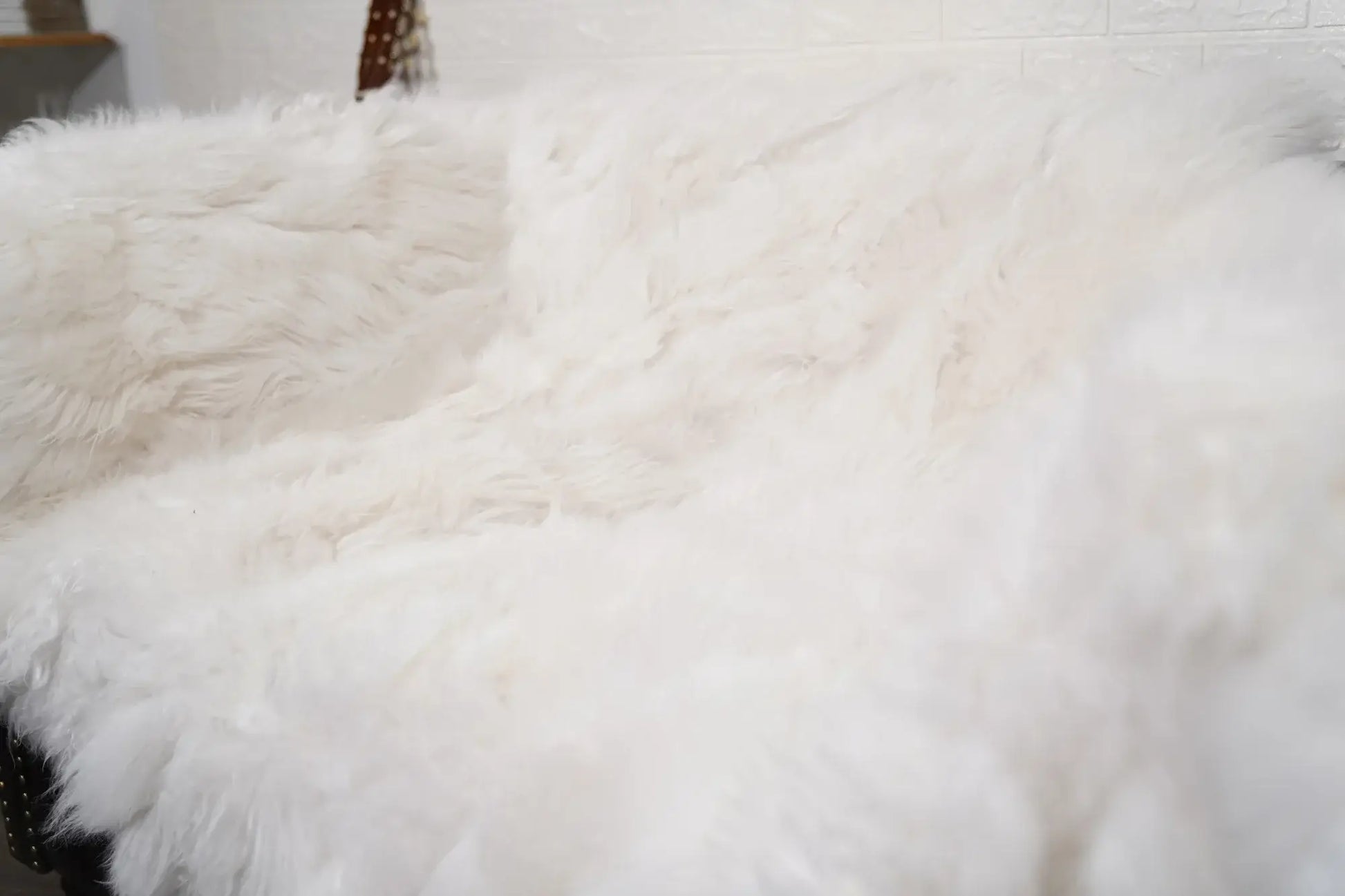 Alpaca throw blanket white corner detail showing natural alpaca wool fiber quality and pure luminous white tone — Greek craftsmanship, TatiFurs
