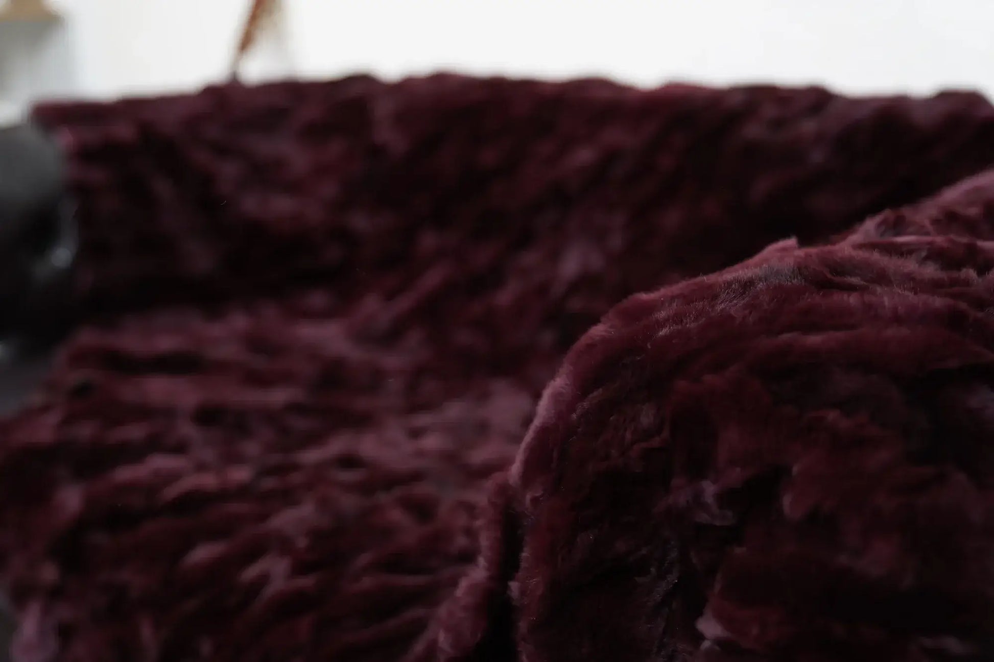 rex rabbit fur throw blanket red burgundy — folded over armchair, dense pile rich colour visible — Greek craftsmanship, TatiFurs
