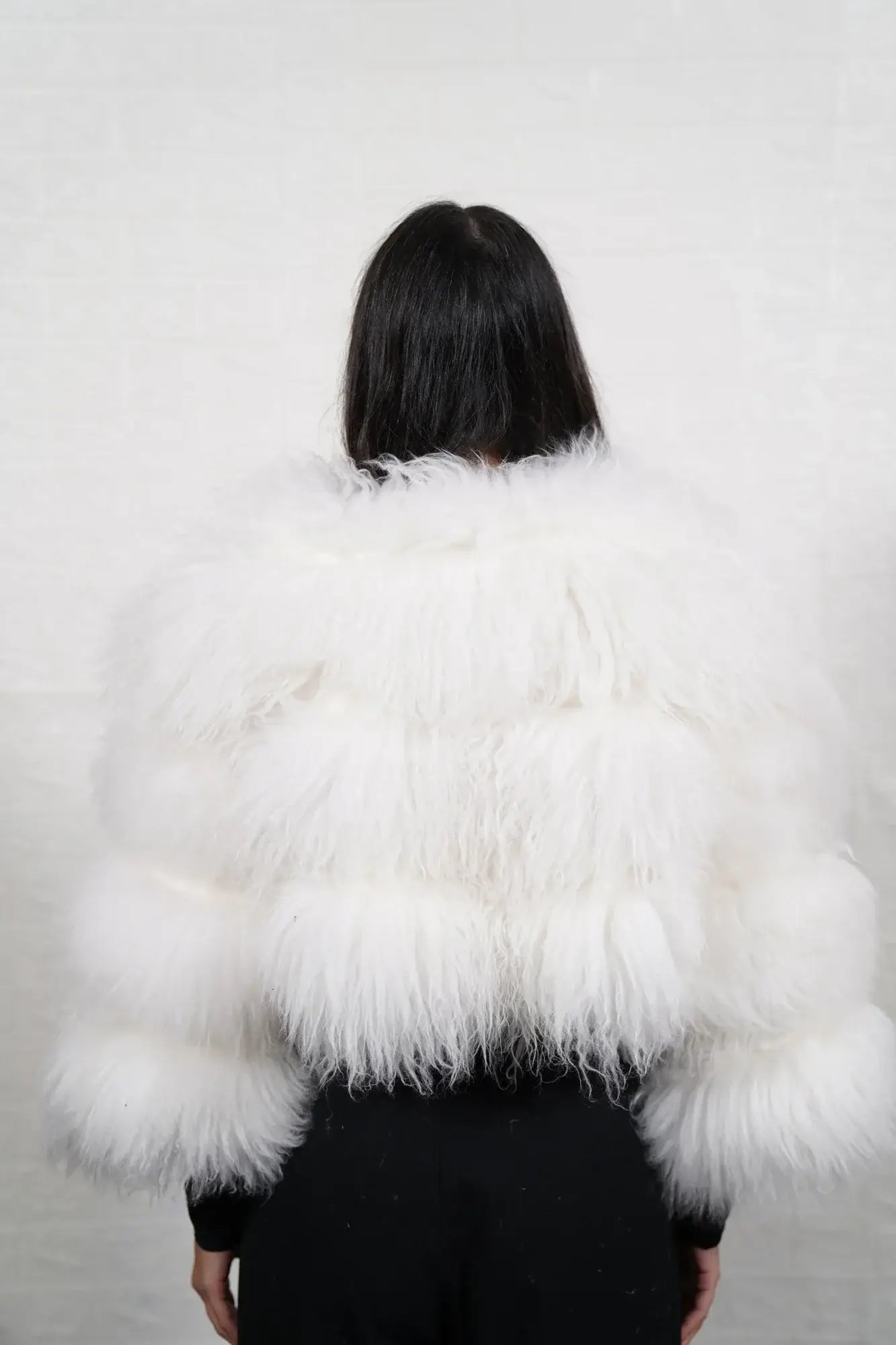 Alpaca fur jacket white shown from the side displaying cropped above waist bomber silhouette and horizontal leather framed luminous white alpaca rows — Greek craftsmanship, TatiFurs
