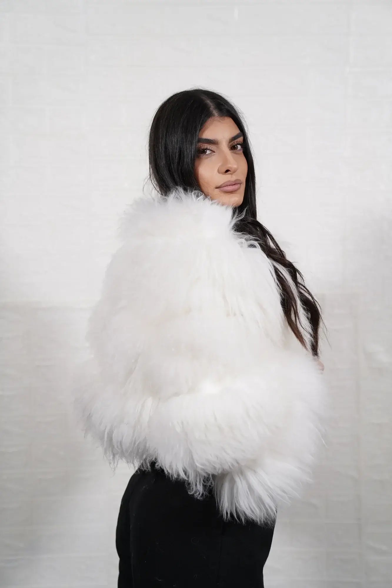 Alpaca fur jacket white shown from the back displaying full cropped bomber silhouette and horizontal leather strip construction across white alpaca rows — Greek craftsmanship, TatiFurs
