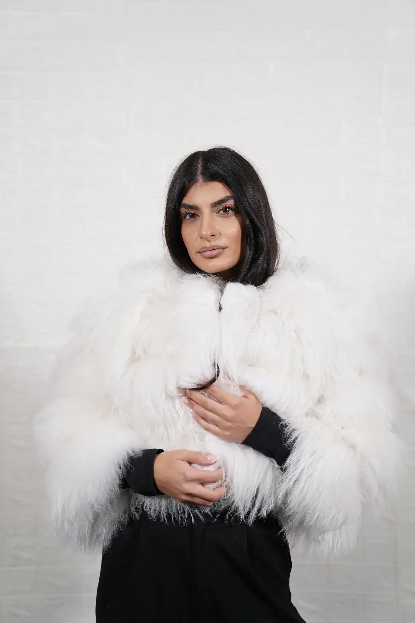 Alpaca fur jacket white close-up texture showing pure luminous white alpaca pile depth and horizontal leather strip construction between fur rows — Greek craftsmanship, TatiFurs
