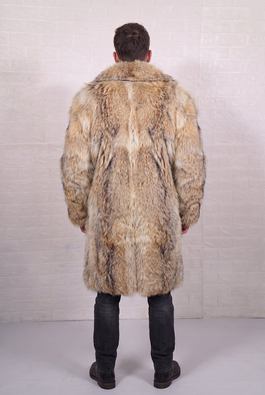 coyote fur coat men shown from the back displaying full long silhouette and consistent warm golden tan with cream and dark-tipped guard hairs pile — Greek craftsmanship, TatiFurs