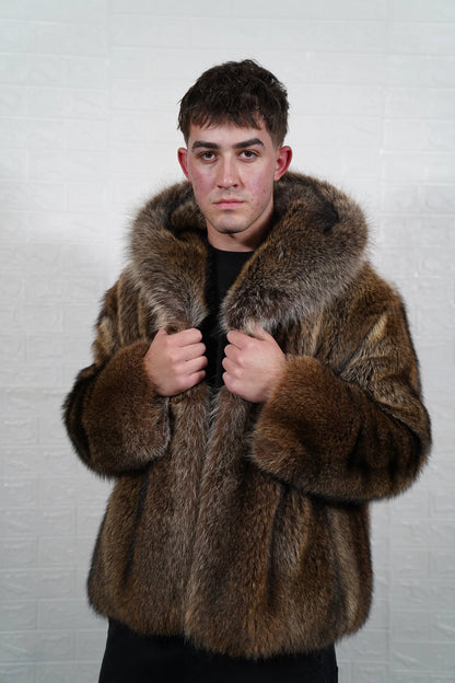 Raccoon fur jacket men natural brown shown from the side displaying below hip silhouette and dramatic natural brown raccoon pile drape — Greek craftsmanship, TatiFurs
