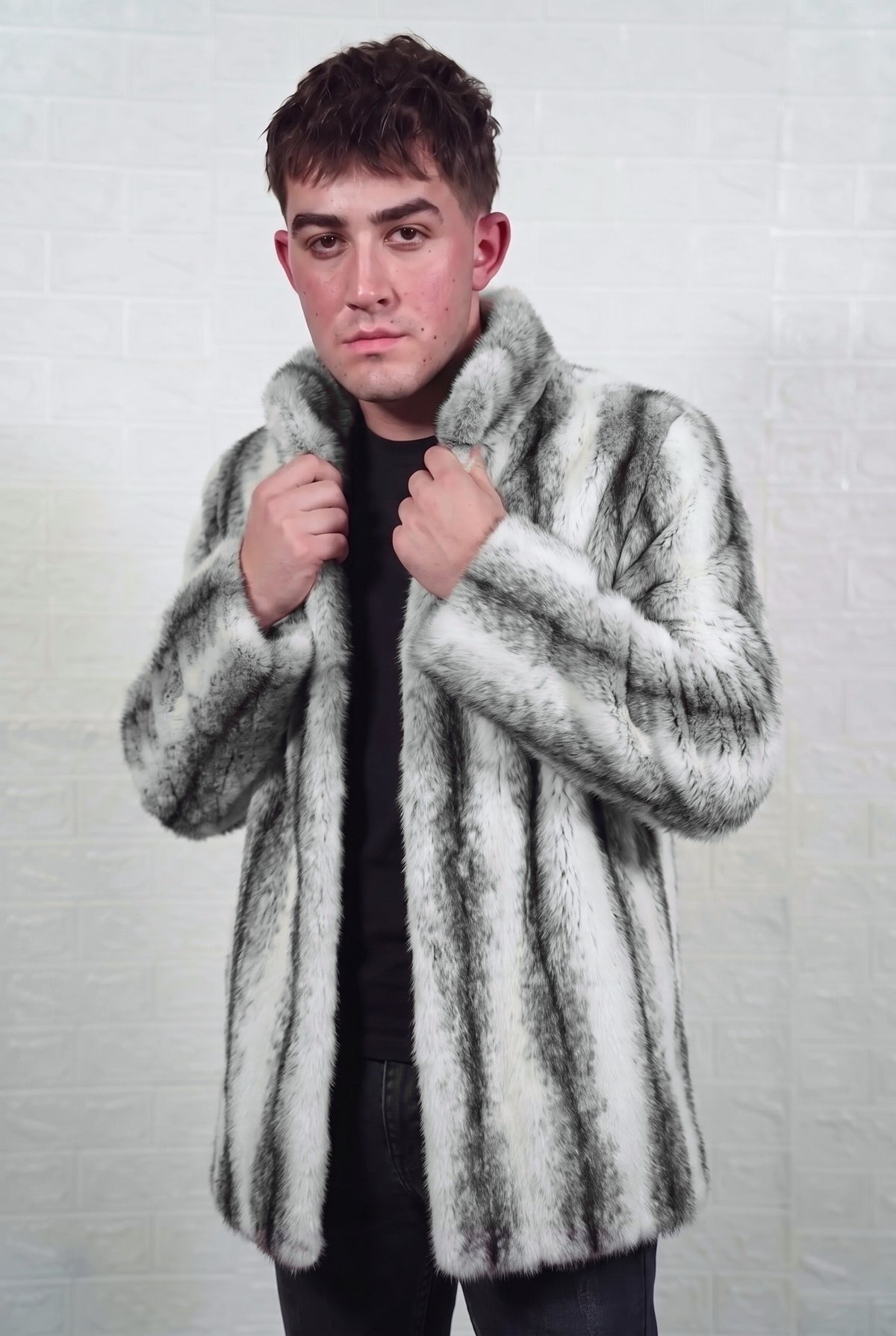 mink fur jacket men black cross full skin mid length — front view with both hands on the stand collar, snow white mink with soft feathered charcoal cross stripes down every pelt — TatiFurs