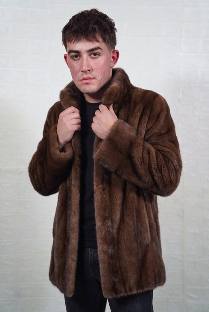 mink fur jacket men brown demi buff full skin mid length — front view with both hands on the stand collar, warm brown demi buff mink with a golden-chestnut glow and darker guard hair — TatiFurs