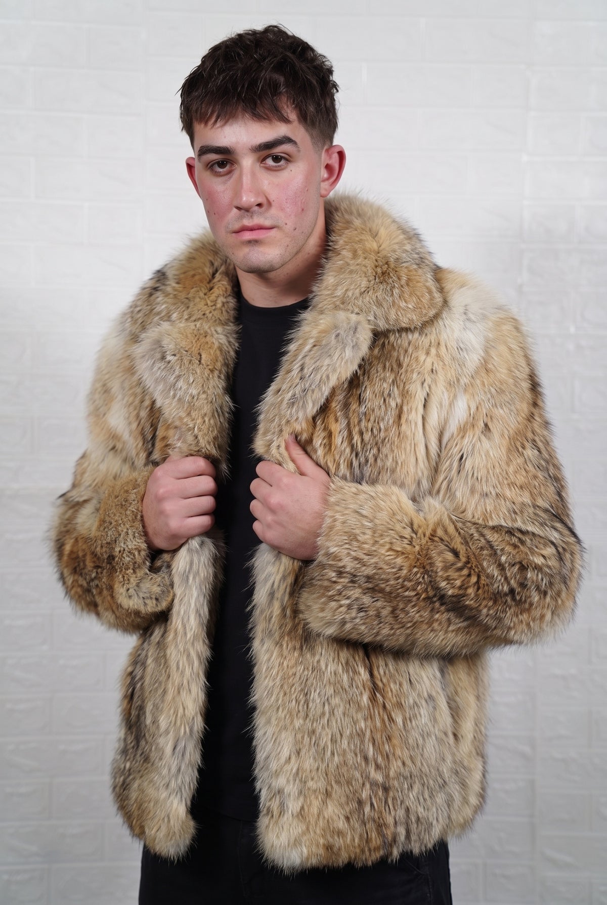coyote fur jacket men front view with hands on the fold-down fur collar showing warm golden tan with cream and dark-tipped guard hairs coyote fur — TatiFurs