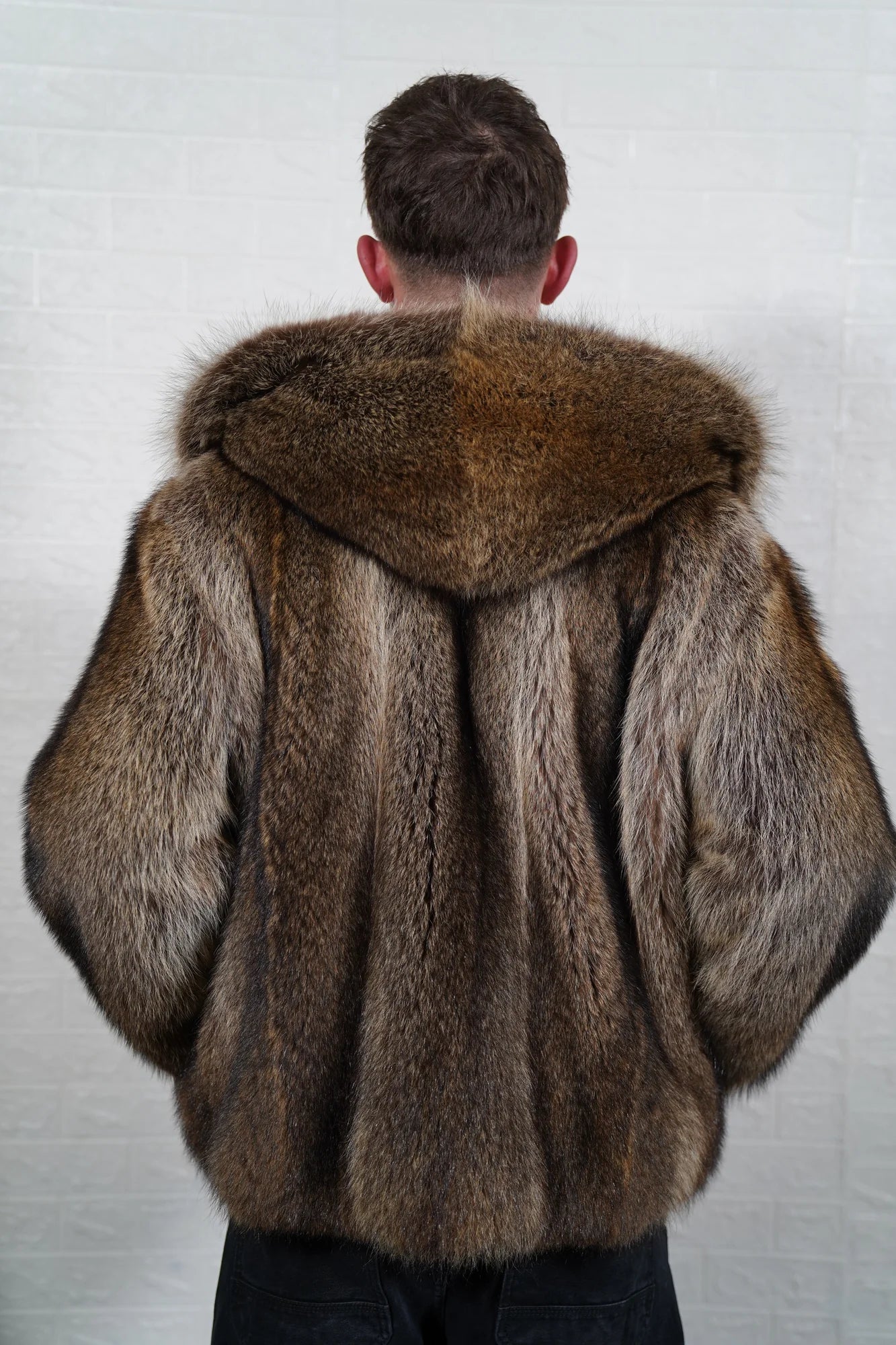 Raccoon fur jacket men natural brown shown from the back displaying full below hip silhouette and consistent natural brown raccoon full skin surface — Greek craftsmanship, TatiFurs
