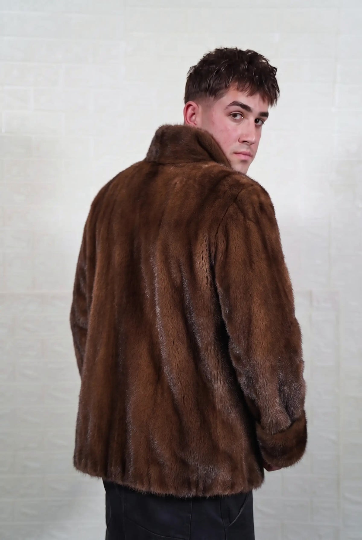 mink fur jacket men brown demi buff three-quarter back view looking over the shoulder, warm brown demi buff mink with a golden-chestnut glow and darker guard hair — Greek craftsmanship, TatiFurs