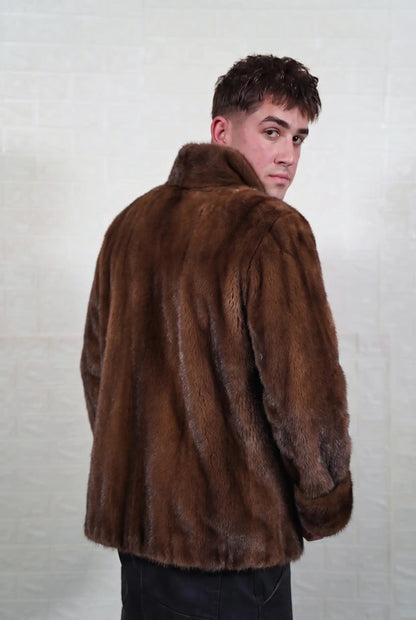mink fur jacket men brown demi buff three-quarter back view looking over the shoulder, warm brown demi buff mink with a golden-chestnut glow and darker guard hair — Greek craftsmanship, TatiFurs