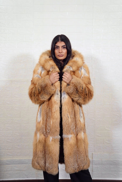 fox fur coat long golden natural front view with both hands on the fur hood worn as a shawl collar showing natural golden fox, warm amber-gold with cream and pale silver highlights fox fur — TatiFurs