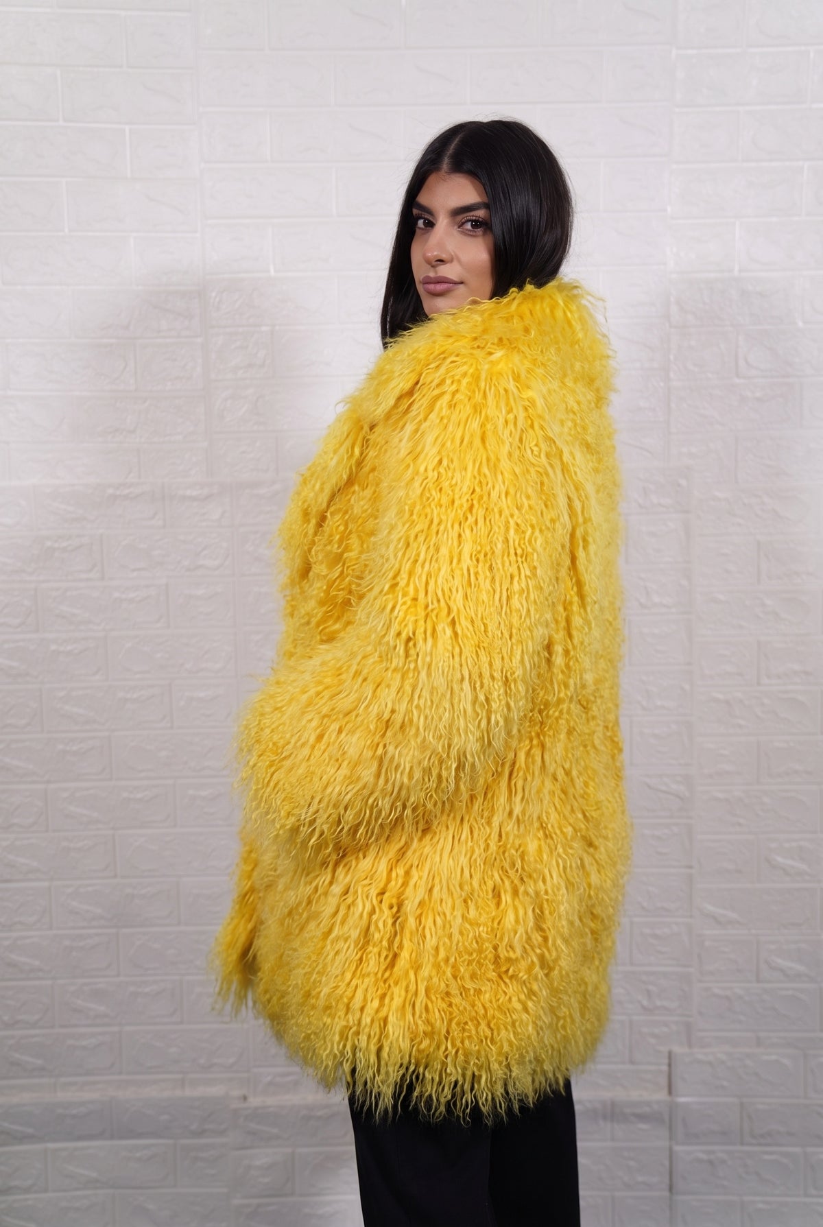 Mongolian coat yellow shown from the side displaying mid-thigh silhouette and bright sunshine yellow long curly Mongolian wool — Greek craftsmanship, TatiFurs