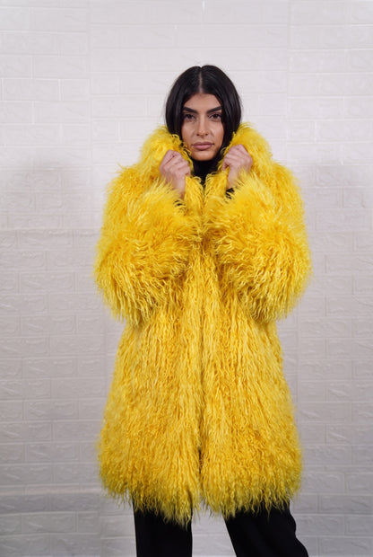 Mongolian coat yellow close-up of the lapel collar turned up, showing bright sunshine yellow long curly Mongolian wool pile depth — Greek craftsmanship, TatiFurs