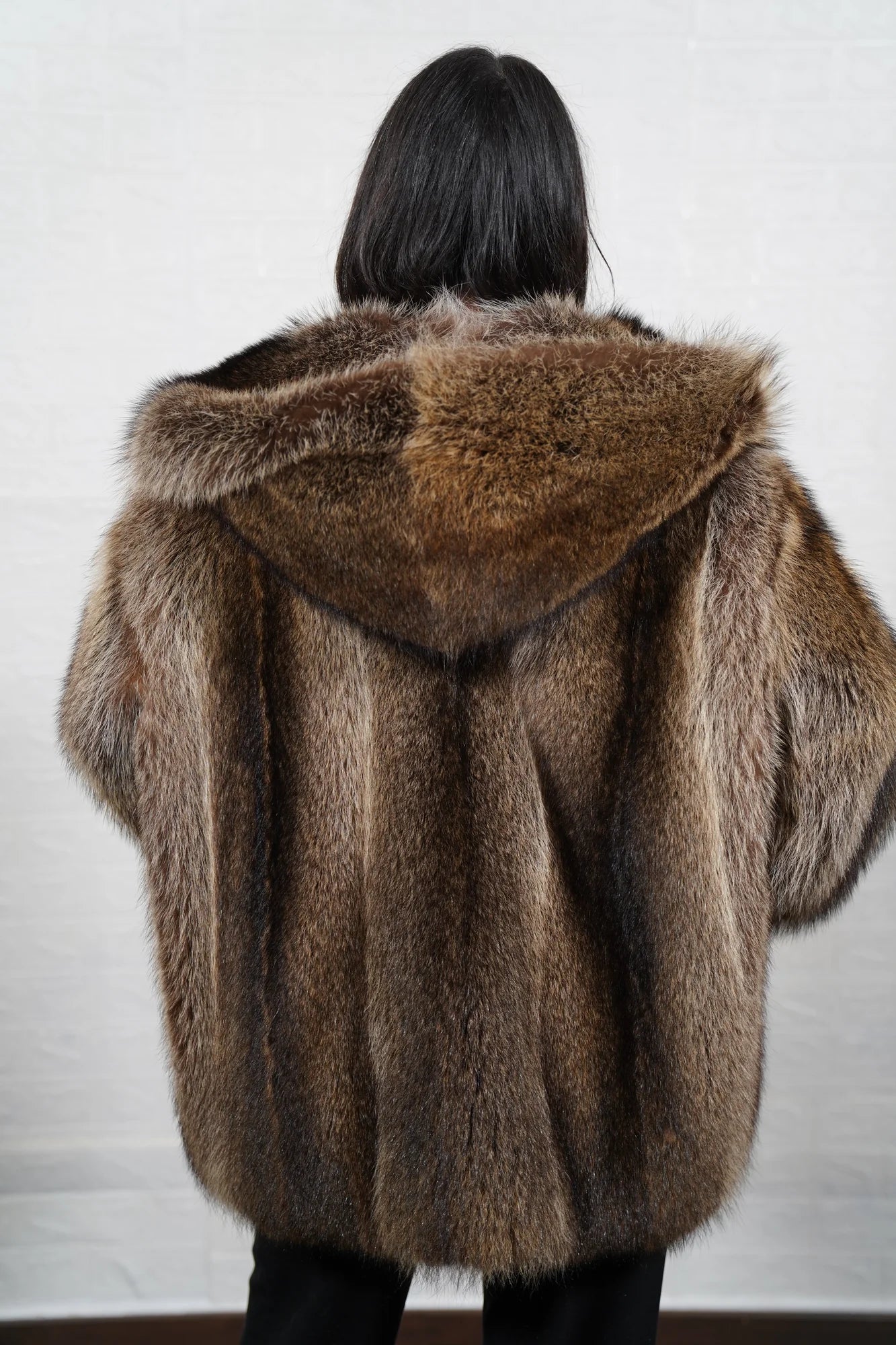 Raccoon fur jacket natural brown shown from the back displaying full below hip silhouette and consistent natural brown raccoon full skin surface — Greek craftsmanship, TatiFurs
