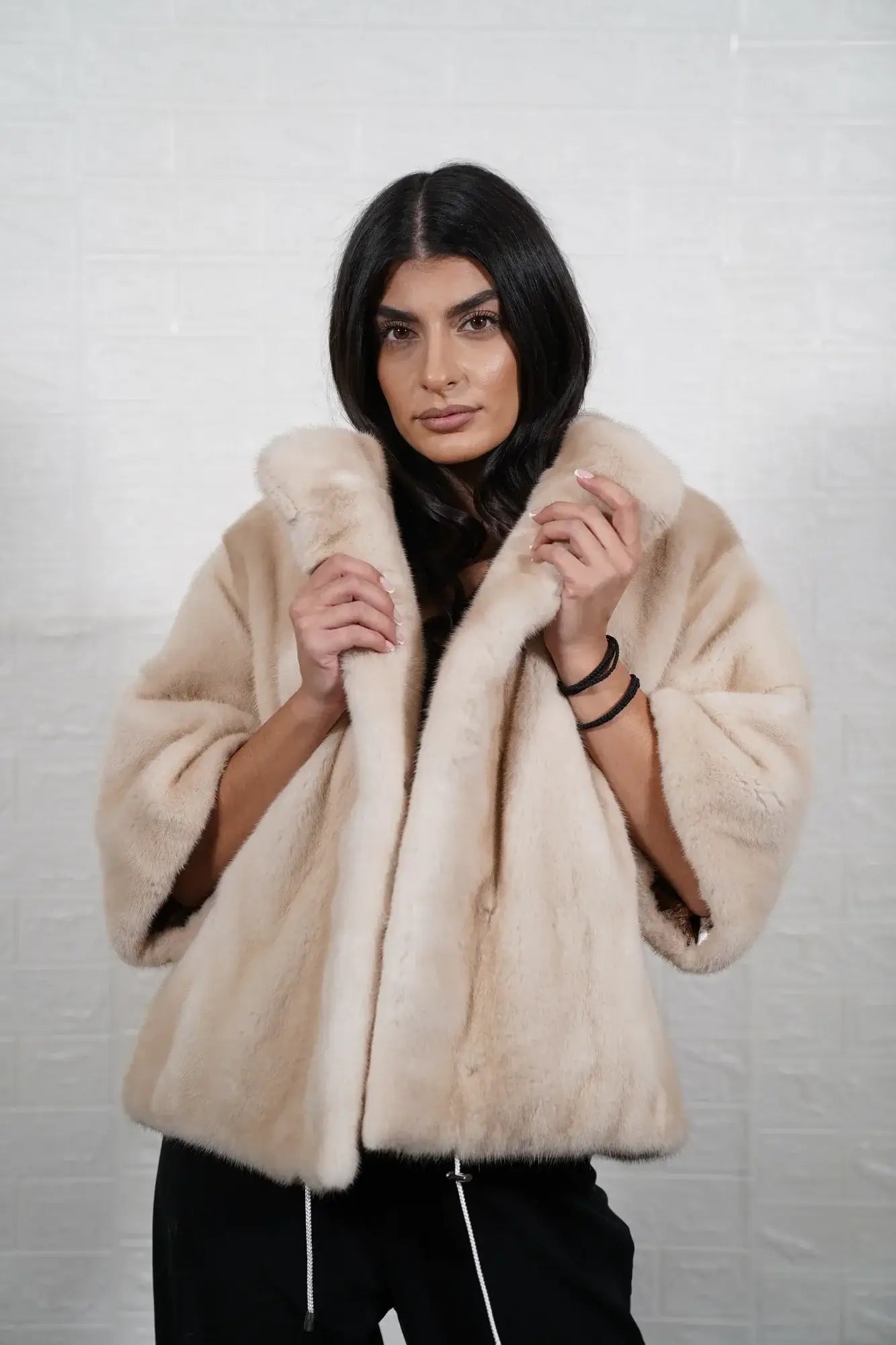 Mink fur jacket pastel ivory shown from the side displaying hip level silhouette and uniform flat ivory solid pattern mink surface — Greek craftsmanship, TatiFurs
