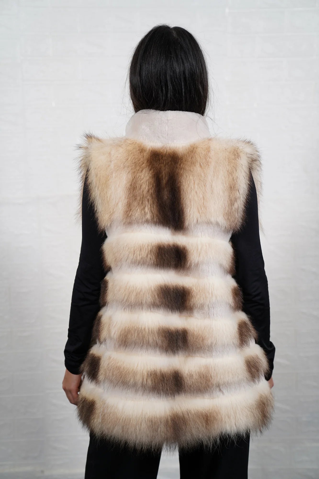 Finn raccoon vest sheepskin lines shown from the back displaying full below hip silhouette and horizontal sheepskin strip construction across Finnish raccoon rows — Greek craftsmanship, TatiFurs
