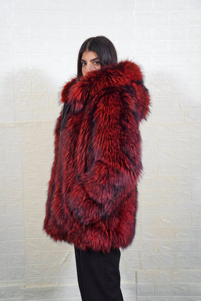 fox fur jacket red black side profile view, chin tucked in the fur, showing deep crimson over jet black fox fur and hip-covering length — Greek craftsmanship, TatiFurs