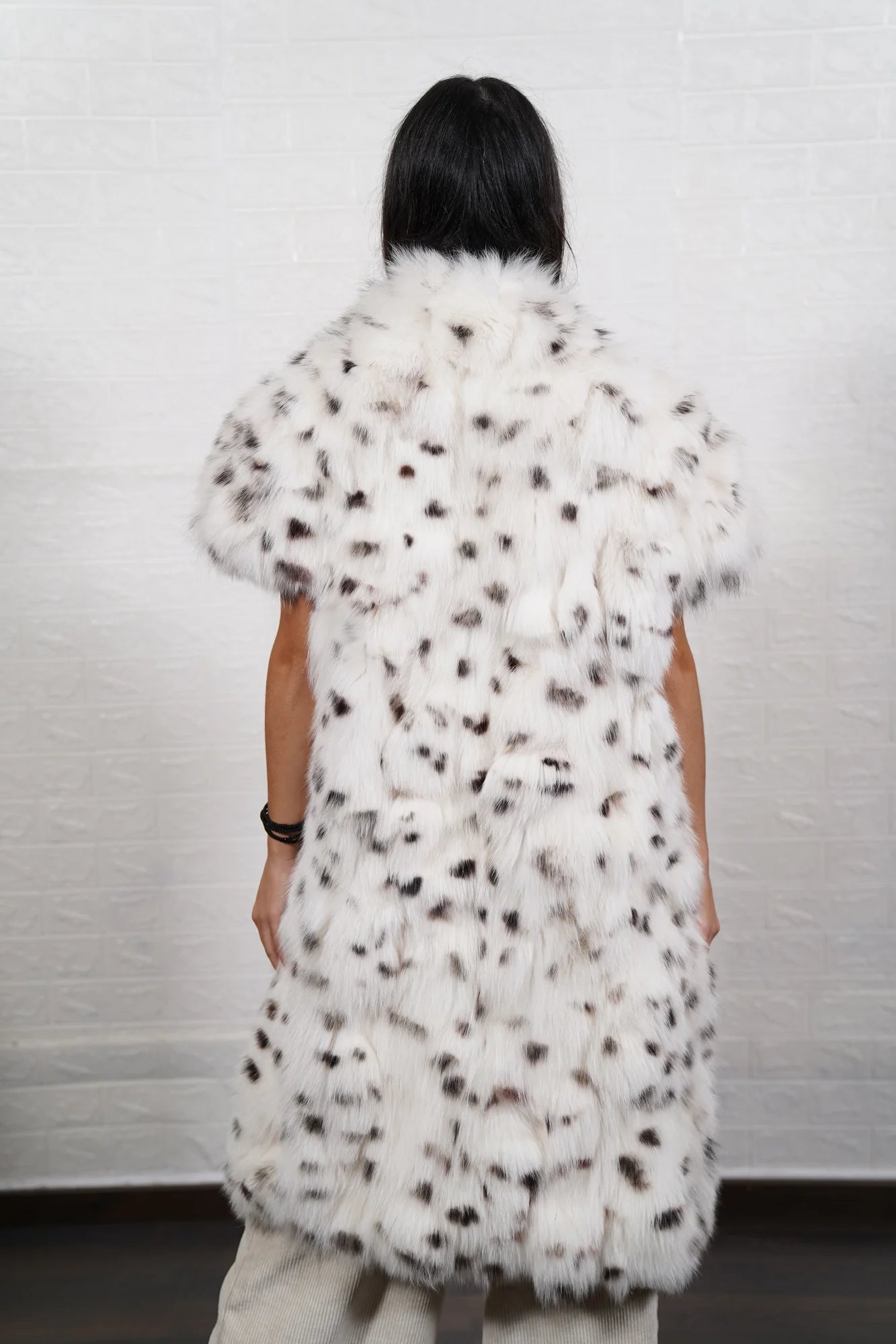 Fox fur vest white dalmatian close-up texture showing natural black spot marking on pure white fox pile across assembled panels — Greek craftsmanship, TatiFurs
