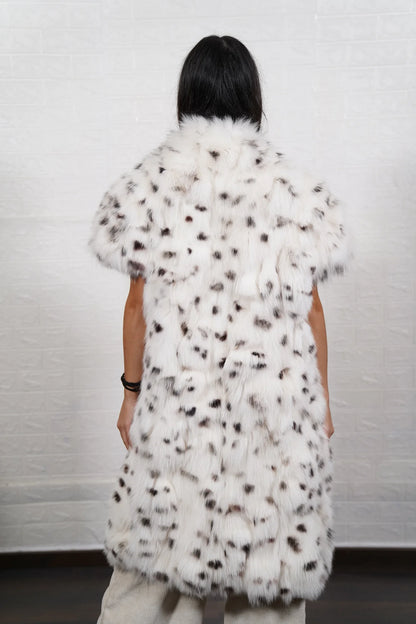 Fox fur vest white dalmatian close-up texture showing natural black spot marking on pure white fox pile across assembled panels — Greek craftsmanship, TatiFurs
