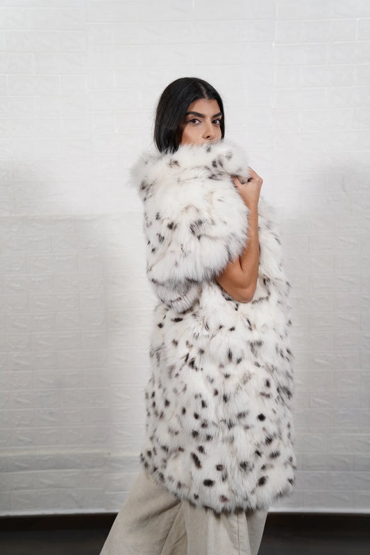 Fox fur vest white dalmatian displaying natural black spotted white fox panels and below knee collared short sleeve silhouette — Greek craftsmanship, TatiFurs
