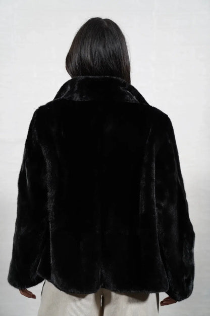 Mink fur jacket black shown from the back displaying full hip level silhouette and consistent flat black solid pattern full skin mink — Greek craftsmanship, TatiFurs
