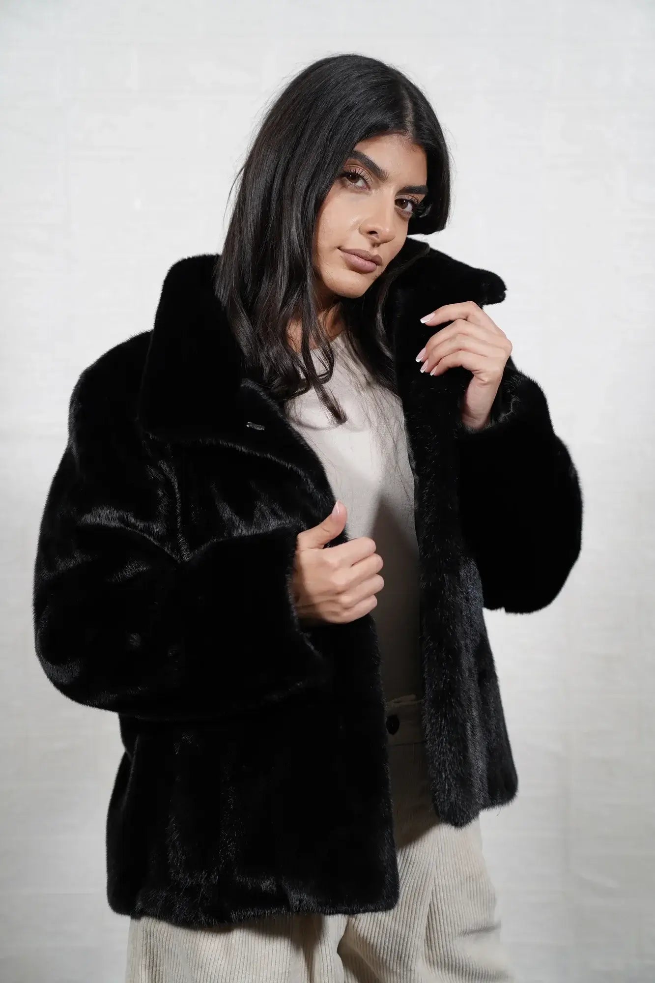 Mink fur jacket black collar close-up showing precise pelt matching between collar and shoulder skins in deep flat black solid mink — Greek craftsmanship, TatiFurs
