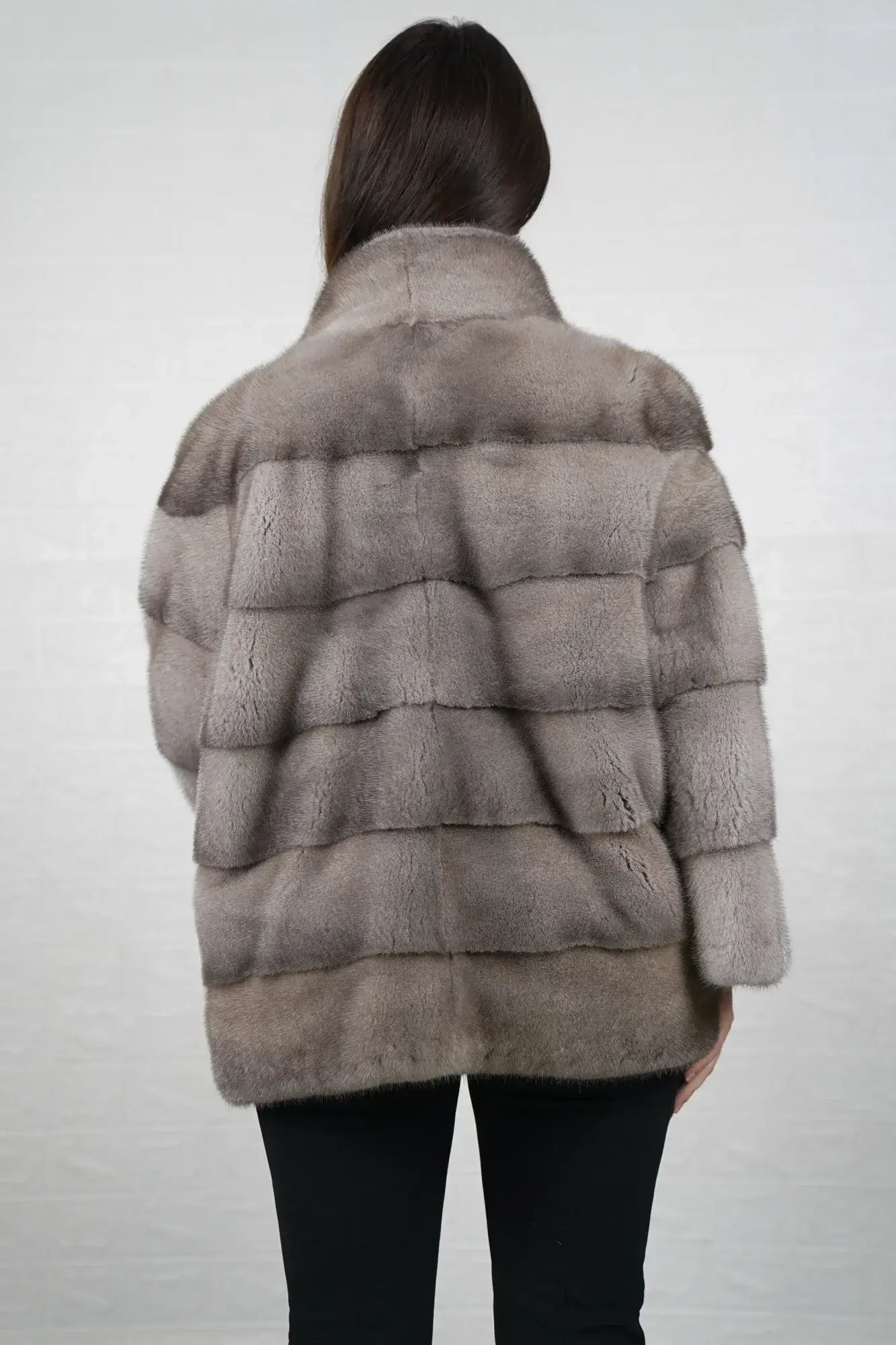 Mink fur jacket silver shown from the back displaying full mid length silhouette and cool luminous silver skin on skin mink flow — Greek craftsmanship, TatiFurs
